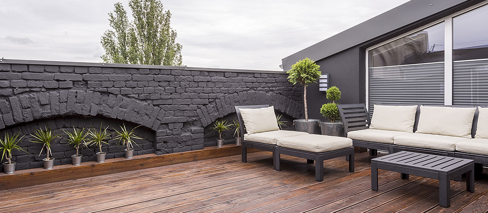 Beautiful rooftop with white sofa chairs on a cloudy day